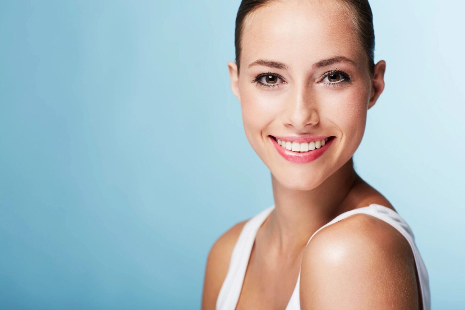 A woman with white teeth smiling for the camera.