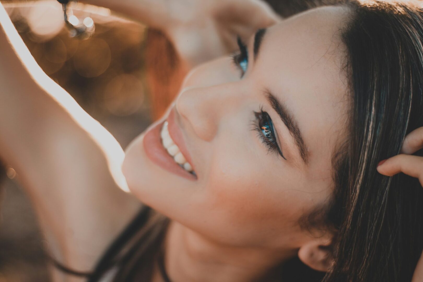 A woman with blue eyes smiling for the camera.