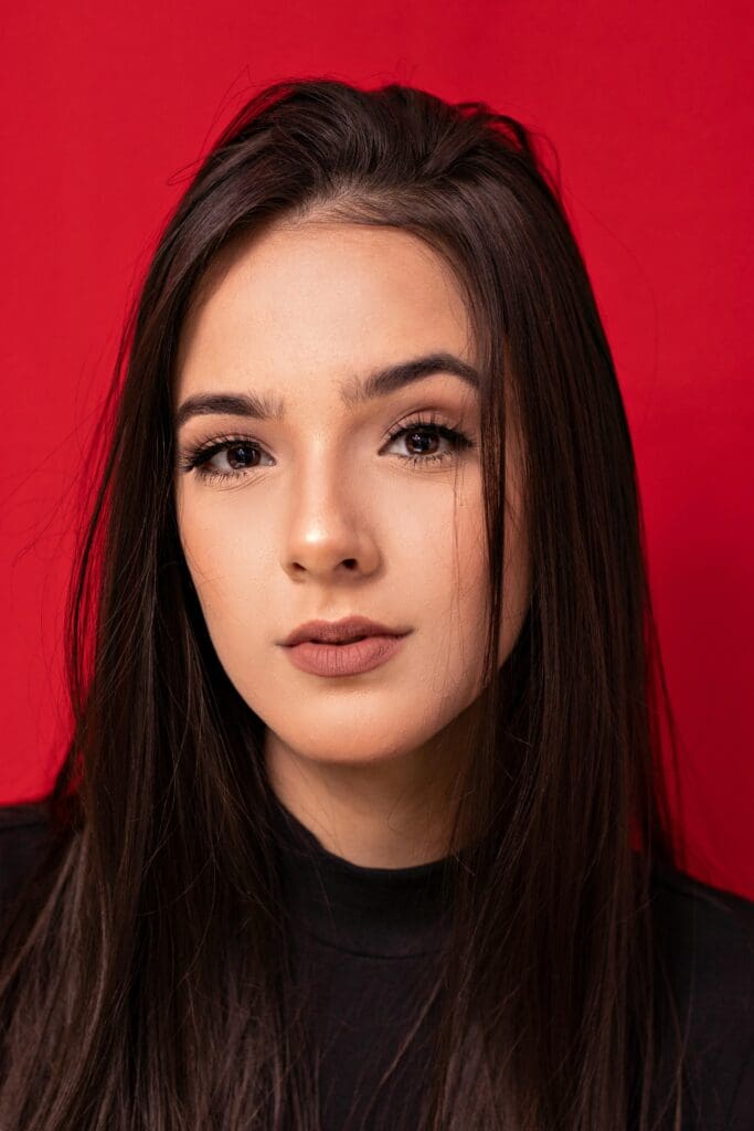 A woman with long hair and a black shirt.