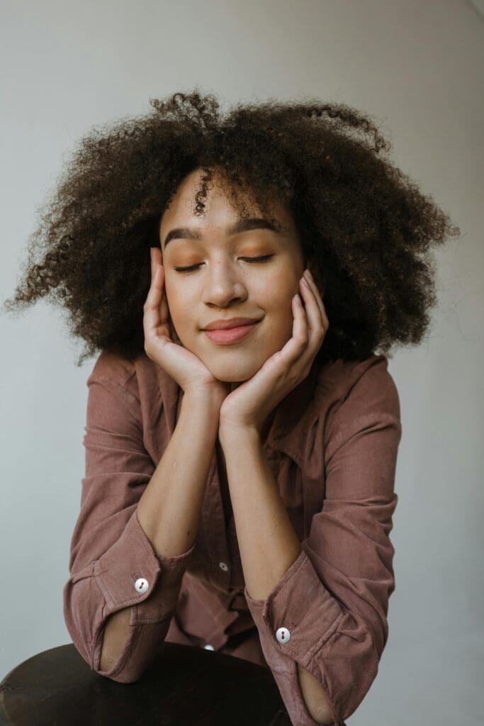 A woman with her hands on her face.