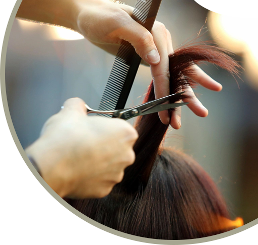 A person cutting another persons hair with scissors.