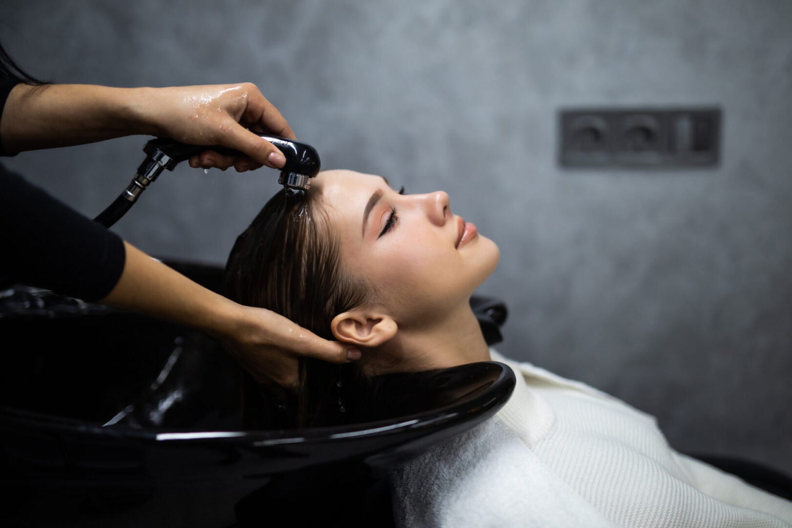 A woman getting her hair washed in the salon.